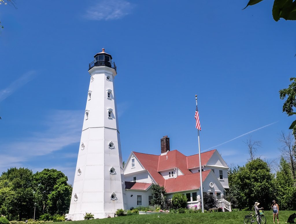 White octagonal lighthouse with adjacent keeper's quarters having white siding and red roof, Lake Park, Milwaukee, Wisconsin, 