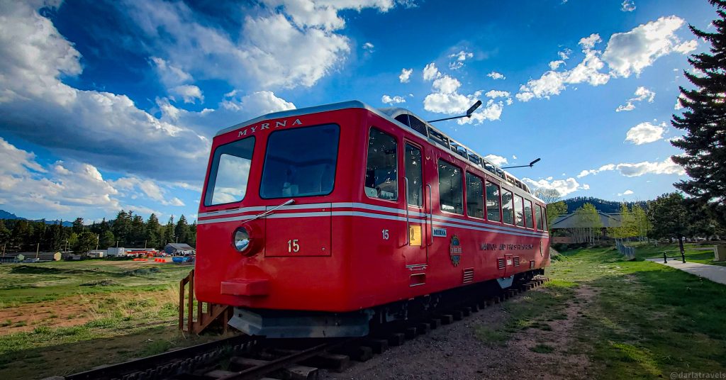 red rail car from a cog railway situated in a park in Woodland Park, Colorado