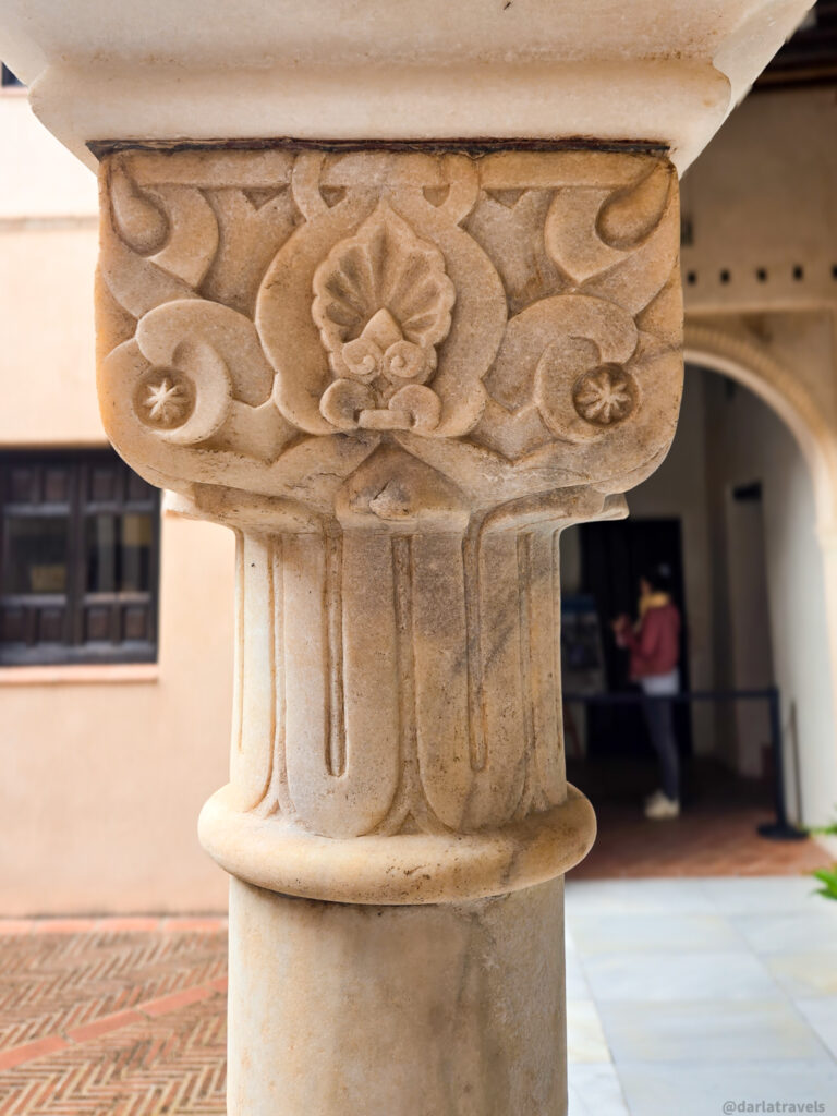 A close-up of an ornate column with intricate carvings and designs.