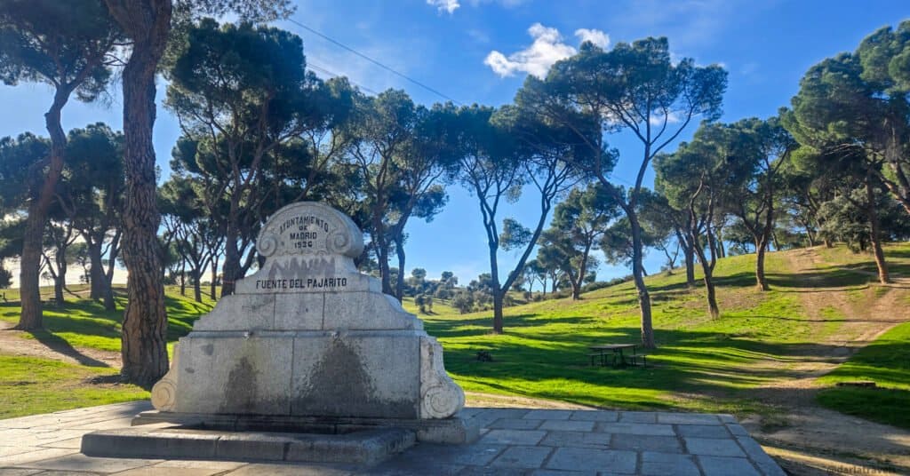 stone fountain with two water taps in Campo de Casa Park Madrid; Lettering: "Fuente de Pajarito"