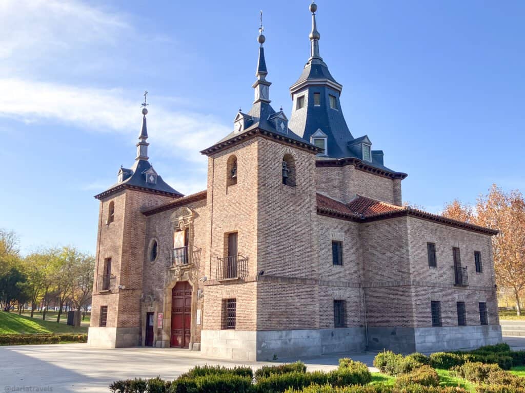 square brick chapel building with spires on corners and on a dome