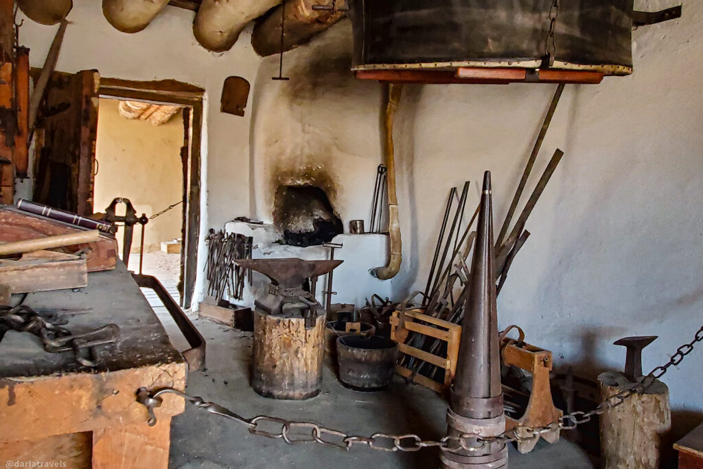 Historic blacksmith forge with anvil, tools, and bellows at Bent's Old Fort, La Junta, Colorado