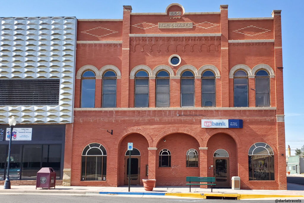 1905 Draper Building with red brick and arched windows in downtown La Junta, Colorado.