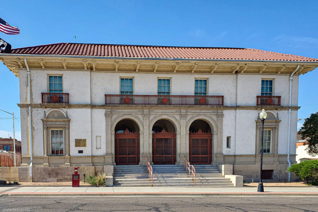 Historic white mission-style building with red accents in La Junta, Colorado downtown district.