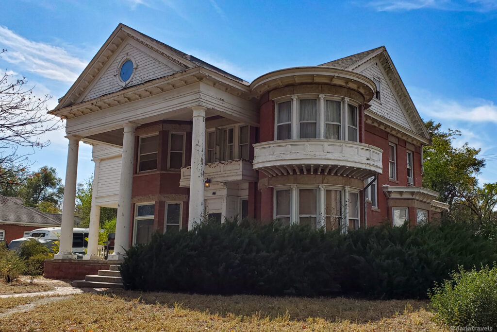 Grand historic home with columns and bay window in La Junta, Colorado’s downtown district.