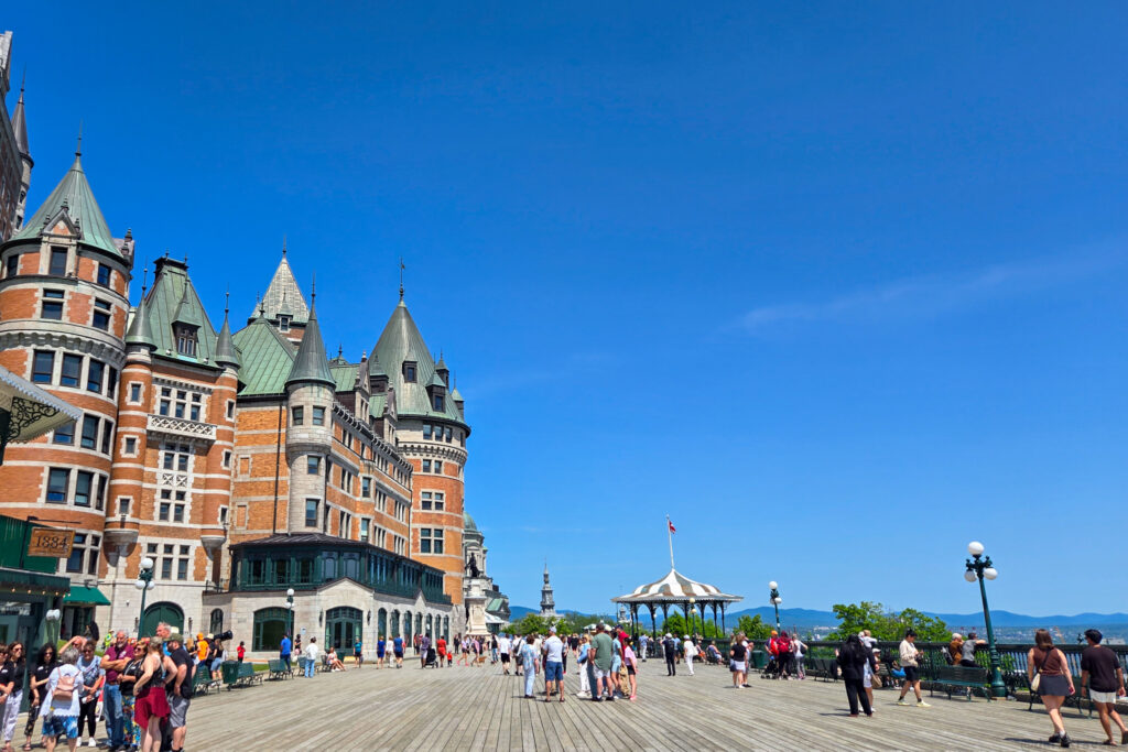 Terrasse Dufferin boardwalk with visitors in front of Château Frontenac and gazebo overlooking St. Lawrence River