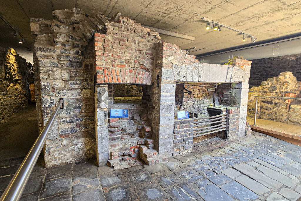 Preserved brick ovens with metal grates and in Quebec City museum exhibit