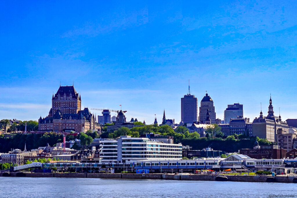 View of Quebec City skyline from across Saint Lawrence River, highlighting Château Frontenac and historic and modern buildings