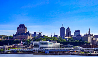 View of Quebec City skyline from across Saint Lawrence River, highlighting Château Frontenac and historic and modern buildings