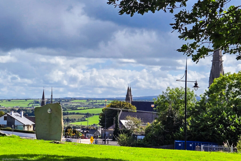 A panoramic view of Letterkenny’s skyline with church spires, historic buildings, and rolling green countryside.
