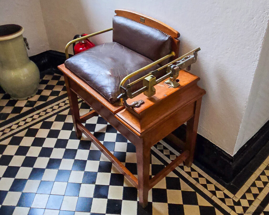 Vintage chair scale with balance beam on checkered floor in Glenveagh Castle entrance hall