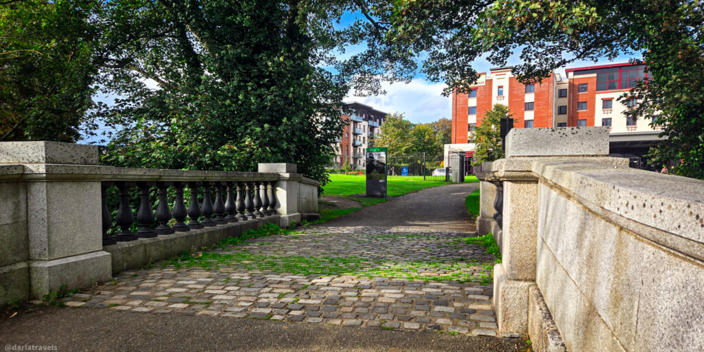 Cobblestone path through stone bridge leading to modern buildings in Santry, near Dublin Airport