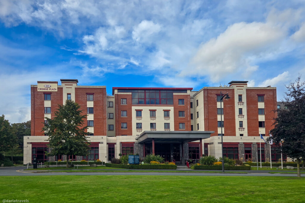 Crowne Plaza Dublin Airport exterior with brick facade, canopy entrance, and landscaped garden
