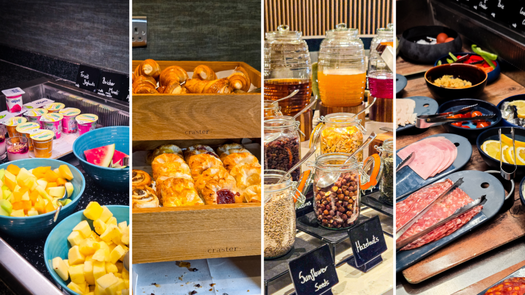 Hotel breakfast buffet with fruit, yogurt, pastries, cold cuts, and cereals