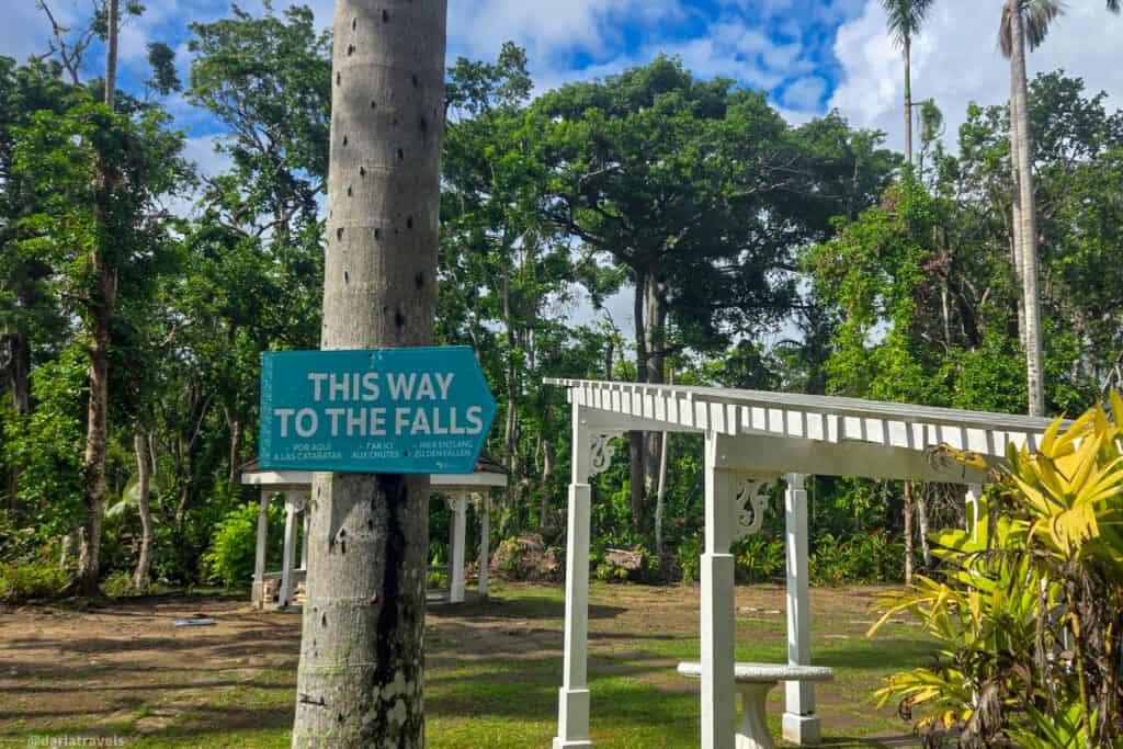 Directional sign guiding visitors toward the start of the Dunn’s River Falls climb.