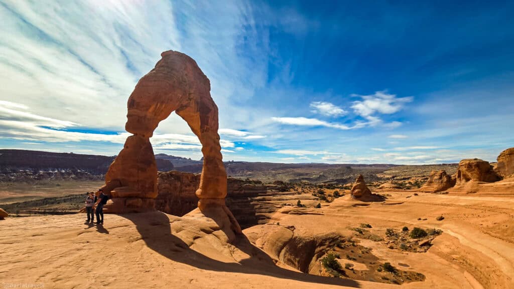Delicate Arch glowing above the red sandstone landscape in Arches National Park.