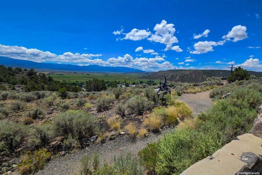 Panoramic view of the green San Luis Valley with mesas and mountains on the horizon in southern Colorado