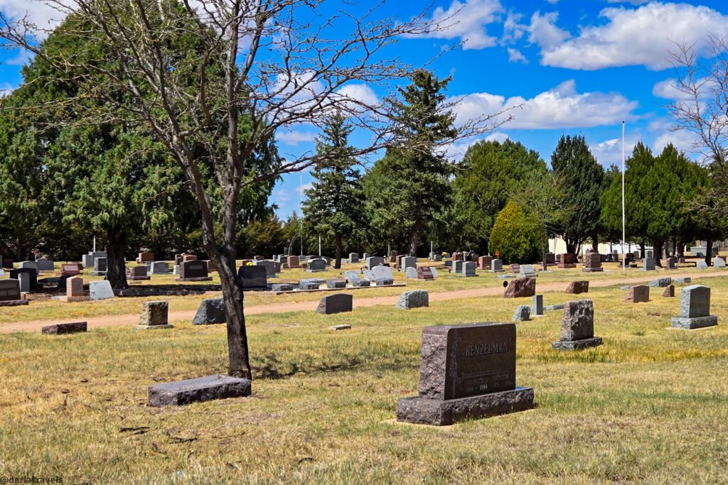 Rows of cemetery headstones surrounded by trees at Grandview Cemetery
