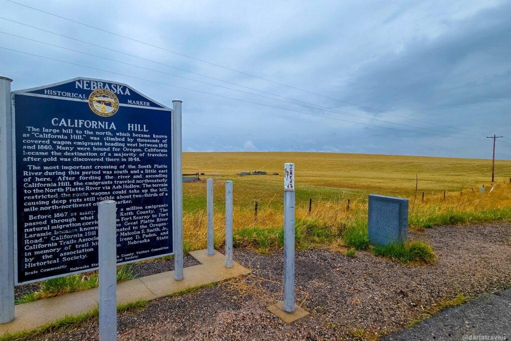 California Hill historical marker and a smaller stone marker beside open grassland near Brule, Nebraska.