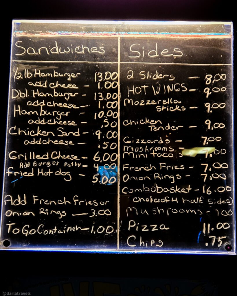Julesburg Tavern chalkboard menu listing burgers, sandwiches, sides, and prices.